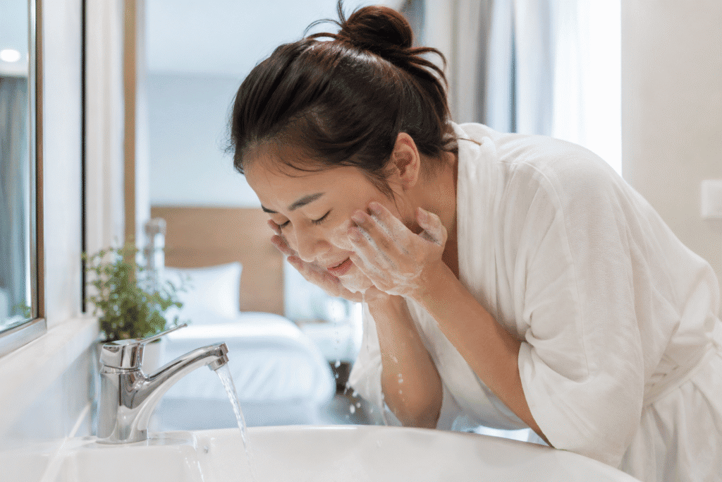 Woman washing her face in the morning.